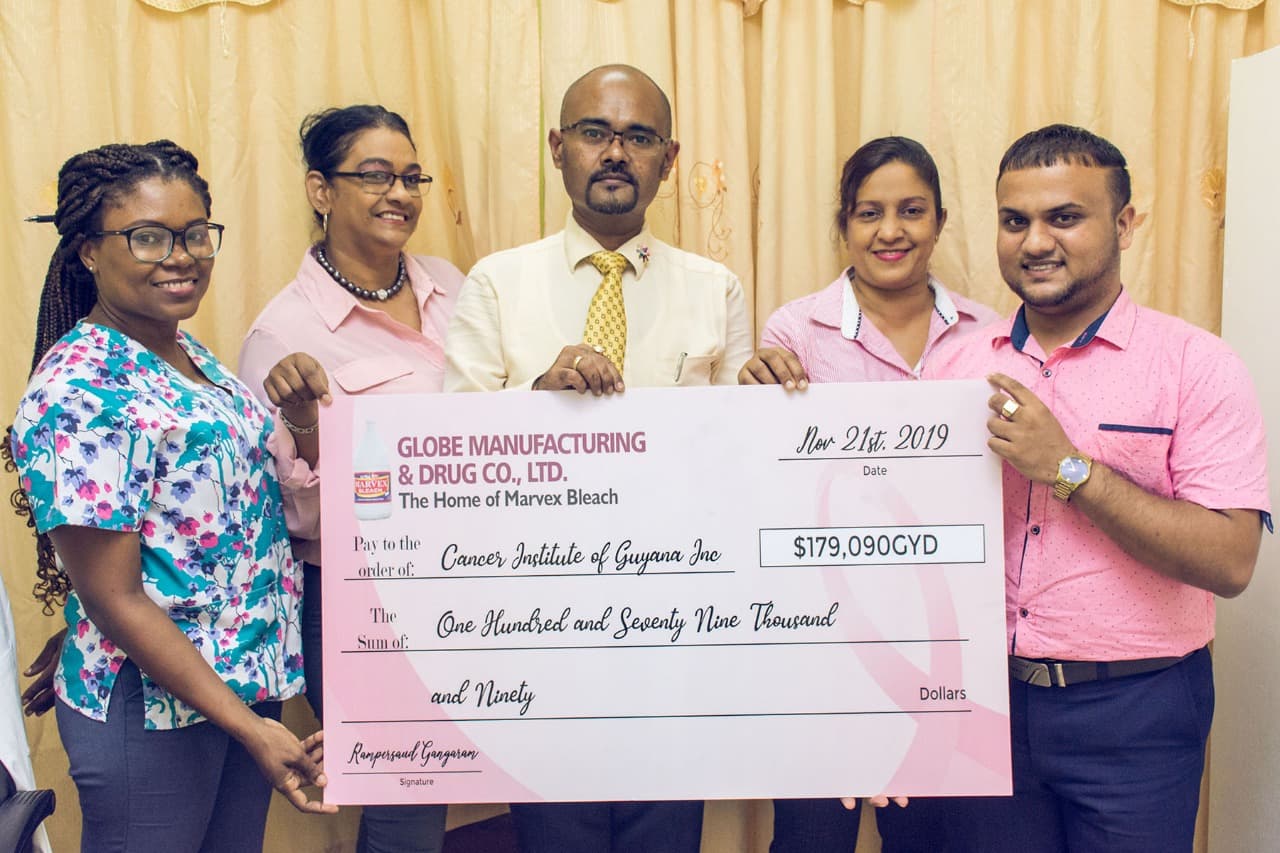 Marvex team giving a cheque for cancer month 